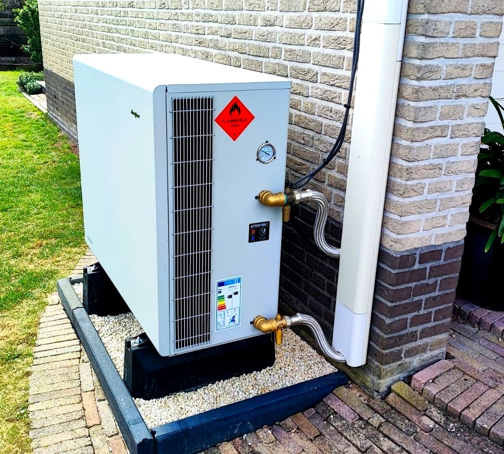 Luft til vand-varmepumpe monteret ved husets gavl